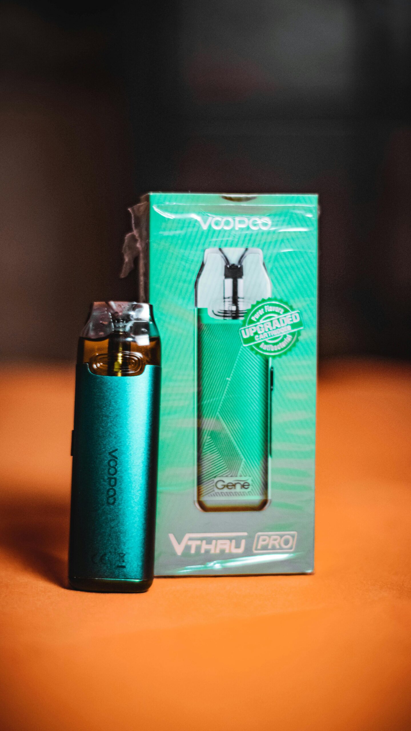 Close-up of a turquoise VooPoo vape and its packaging, perfect for product photography.